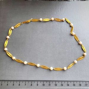 Gold tone leaf like link necklace with white beads